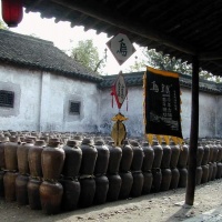 Tradition is still very much alive in Wuzhen. In addition to flower-drum opera, Shadow-puppet shows, and temple fairs, Wuzhen also attracts visitors with its time-honored art of making indigo-dyed printed calico. In ancient times, indigo-dyed printed calico was used for curtains, scarves, and tablecloths in every household in the countryside of Zhejiang Province. Today, it is still common to see old women in indigo-blue gowns leisurely operating spinning wheels or looms at weaving workshops in the old lanes of Wuzhen, while the squeaks of the looms resound throughout the lanes. Carrying o-n this tradition has become a part of the lives of the old women.